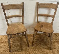 A pair of distressed pine shelf back kitchen chairs on turned legs AF