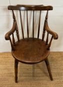 A vintage oak Penny carver arm chair, spindle back and on turned legs