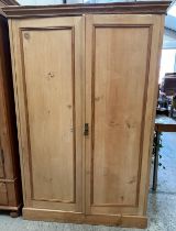 A distressed pine two door cupboard opening to four shelves (H168cm W109cm D46cm)