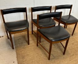 A set of four black leather upholstered McIntosh dinning chairs