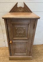 A wooden floor standing side cabinet with carved galleried top and a single shelf cupboard with