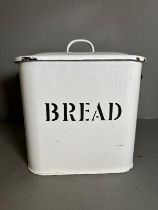 A vintage white enamel bread bin
