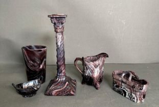 A selection of Sowerby purple glass items to include candle stick, milk jug and a salt