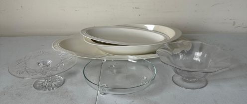 A collection of white ceramic plates and glass dishes