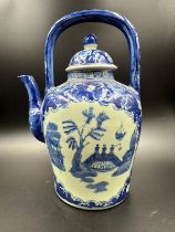 A blue and white Chinese ironstone kettle in the willow pattern