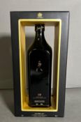 A bottle of 12 year old Johnnie Walker Black label anniversary edition whiskey