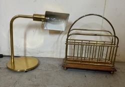A brass desk lamp and a brass magazine rack