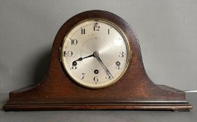An oak cased Napoleons hat mantel clock