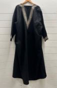 A black West African Kaftan with embroidered cuffs and edging