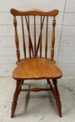 A vintage spindle back Windsor chair on turned legs and stretches