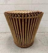 A bamboo coal bucket with red metal insert