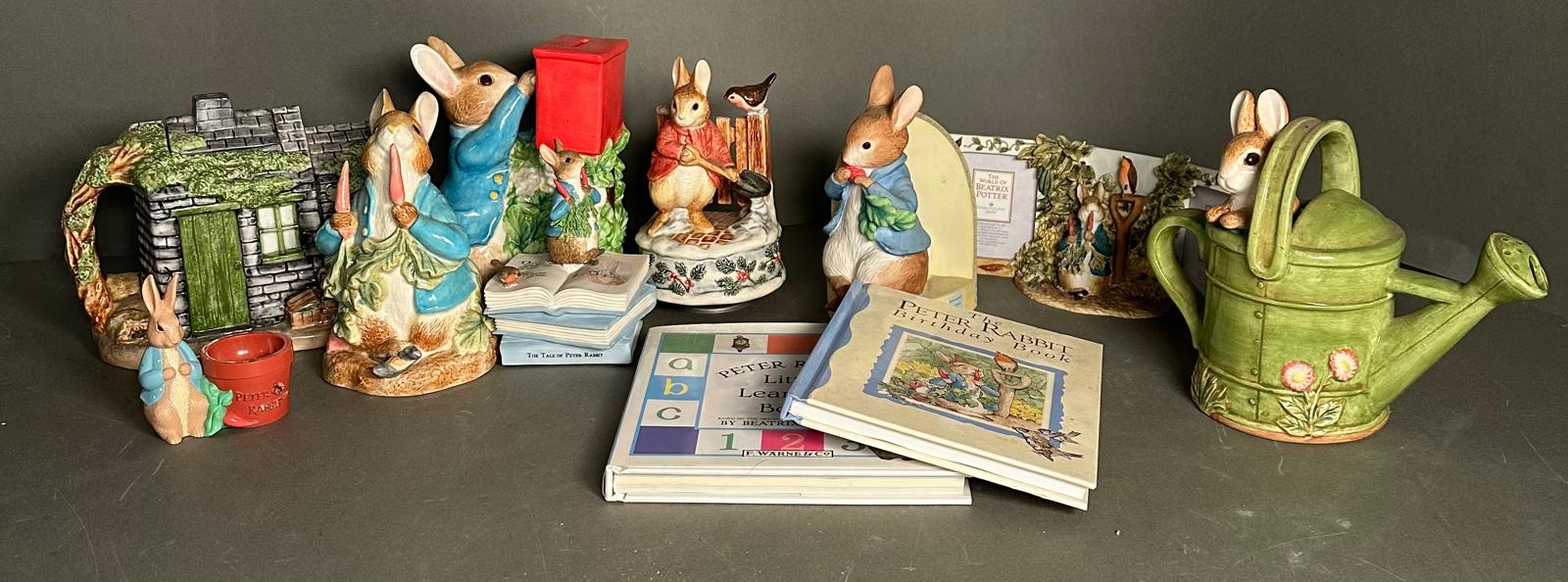 A selection of Bextrix Potter Peter Rabbit collectable to include money boxes, books and a tea pot