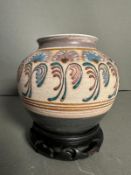 An Arts and Crafts style stoneware vase with floral painted relief