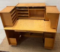 A metamorphic magic box desk, the doors open to reveal a desk with compartments and a drawer (H115cm