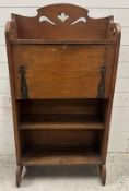 An oak Arts and Crafts bureau bookcase with a galleried top, the fall opening to Pigeon holes and