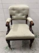 A mahogany carved open arm chair on castors in a pale green upholstery
