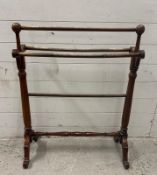 A Mahogany towel rail with turned supports and stretcher on splayed legs