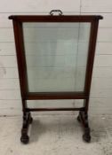 A large mahogany Georgian glazed fire screen on splayed legs with sliding glass panel (H108cm