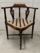 An Edwardian inlaid corner chair upholstered in a floral pattern