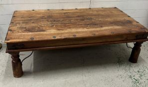 A hardwood coffee table with metal details (H40cm W134cm D75cm)