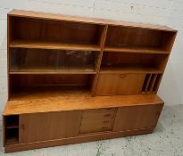 A Mid Century room divider by Clausen and Sons, the 1960's wall unit has sliding doors and drawers