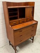 Mid Century teak bureau desk, sliding door to front and three drawers under (H125cm W77cm D41cm)