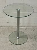 A glass side table on chrome central column (H58cm Dia45cm)