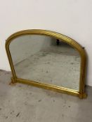 A Gilt framed arched wall mirror by Laura Ashley