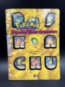 A selection of nine 2000 Pikachu Pokemon cards in a Pikachu World Collection folder.