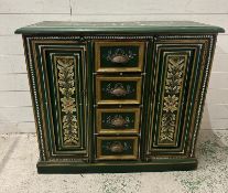 A rustic green and florally painted cupboard with four short drawers to centre and flanked by