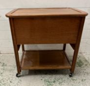 A Mid Century teak work box on castors with shelf under H62cm W62cm D44cm)