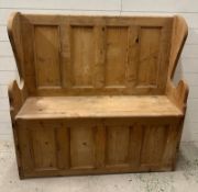 A reclaimed pine settle or bench with hinged lift up seat opening to storage (H122cm W123cm D36cm)