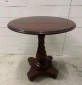 A mahogany pedestal side table on spiralized turned column and four bun feet (H64cm Dia61cm)