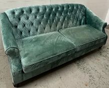 Four seater sofa in plush teal velvet with button back (H95cm W207cm D80cm)