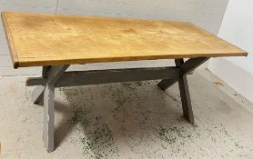 A large pine farmhouse table on X frame legs (H79cm W218cm D82cm)