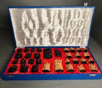 Hand carved chess set made of sandalwood and ebony in lined blue box