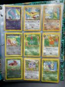 A selection of eighteen 2001 Pokemon cards in a Southern Islands collection folder.