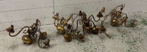 A selection of four brass chandeliers or ceiling lights