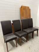 A contemporary hardwood dining table and four faux black leather chairs
