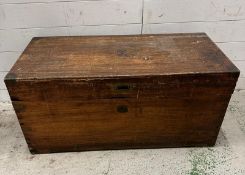 A campaign style camphor wood trunk with brass handle and brass detail to corners, opening to