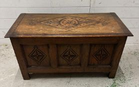 An oak panelled chest with hinged lid (H50cm W91cm D43cm)