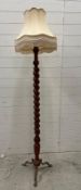 An oak barley twist floor lamp on brass lions paw tripod legs
