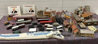 A train set with track, buildings, rolling stock and several engines.