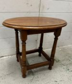 A vintage light oak oval side table (H46cm W51cm D35cm)