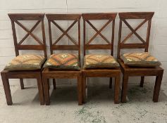 A set of four hardwood cross back dining chairs