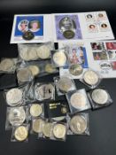 A selection of coin covers, crowns and other collectable coins including one and two pound coins.
