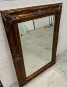 A Baroque style copper effect over mantle mirror 87cm x 118cm