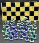 An Indian enamel chess set one side turquoise and other blue inset with stones, the pawns as