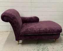 A chaise lounge with scroll arm on turned legs