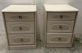 A pair of white contemporary three drawer bedside tables